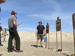 Riley Bowman Listens to Pistol Intelligence Student