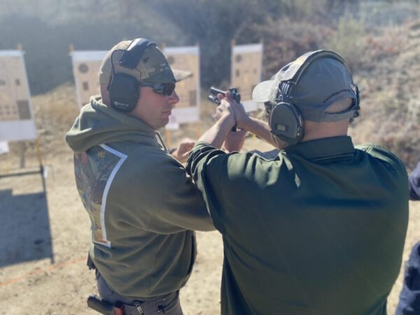 Riley Coaches a Student on the Firing Line